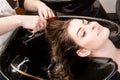 Woman washing her hair in hairsalon