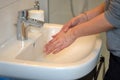Woman washing her hands under running water Royalty Free Stock Photo