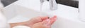 Woman washing her hands under water from tap in bathroom closeup Royalty Free Stock Photo