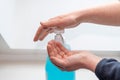 Woman washing her hands using hydroalcoholic gel