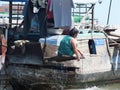 Woman washing herself on a boat Cai Rang floating market, Can Tho