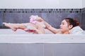 Woman washing leg with sponge in bathtub in the bathroom Royalty Free Stock Photo