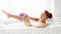 Woman Washing Leg With Sponge In Bath With Foam Royalty Free Stock Photo