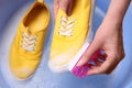 Woman washing shoe with brush in basin, closeup Royalty Free Stock Photo