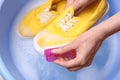 Woman washing shoe with brush in basin Royalty Free Stock Photo