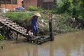 Woman washing on the shore of the Mekong river in Can