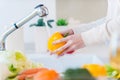 Woman washing vegetables. Royalty Free Stock Photo