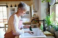 Woman washing vegetables indoors at home when cooking, corona virus concept. Royalty Free Stock Photo