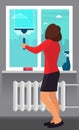 Woman washing the window with a scraper. Window cleaning. Scraper glides over the glass, making it clean. Spray glass cleaner and