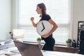 Woman with watch in her hand runs to or from work. Royalty Free Stock Photo