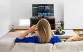 Woman watches Smart TV at home