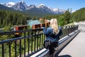 Woman watches a freight train pass through Morants Curve in Banff National Park Royalty Free Stock Photo