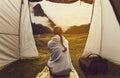 Woman watches landscape from tent