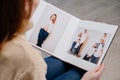 woman watches photobook from photo shoot of family.