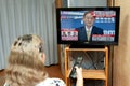 Woman watches the press conference broadcast live on Japanese television by Yoshihide Suga, the new leader of the Liberal