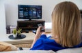 Woman watches Smart TV at home