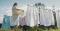 Woman watching bed linens dry in the backyard of the house Royalty Free Stock Photo