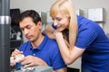 Woman watching dental technician applying porcelain