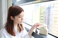 Woman watching the house near the window