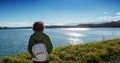 Woman watching lake Gabas in the Pyrenees Atlantiques, mountains in the background