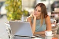 Woman watching a laptop in a restaurant