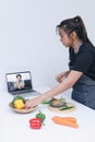 Woman watching and learn online cooking courses in the kitchen. Watching Cooking Video. Royalty Free Stock Photo