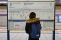 A woman watching the map at subway station in Kyoto
