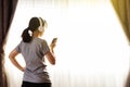 Woman watching online tutorials on mobile phone, training in living room