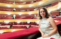 Woman after watching performance poses in auditorium balcony of opera theater Royalty Free Stock Photo