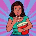 Woman watching a scary movie and eating popcorn Royalty Free Stock Photo