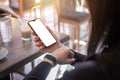 Woman watching smart phone and smart bracelet. hone with blank screen for mockup