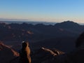 A woman watching the sunrise on the top of mountain Moses in Saint Catherine in Sinai Royalty Free Stock Photo