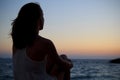 Woman watching the sunset by the sea Royalty Free Stock Photo