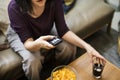 Woman watching television on the sofa Royalty Free Stock Photo