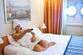 Woman watching TV on her bed Royalty Free Stock Photo