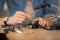 woman watchmaker repairing old watch