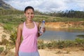 Woman, water bottle and portrait, running and nature with fitness and health, hydration and wellness. Sports, runner by