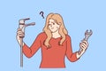 Woman with water faucet and wrench does not understand how to fix water supply or get rid of leak