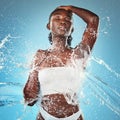 Woman, water splash and skincare body, beauty moisturiser or hydration by blue background wall. Black woman, skin model Royalty Free Stock Photo