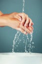 Woman, water and washing hand zoom on studio background, hygiene and skincare with beauty. Health, wellness and