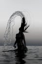 Woman in water waving hair.