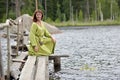 Woman by the water with a wreath in her hands Royalty Free Stock Photo