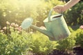 Woman with watering can in garden. AI generated