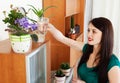 Woman watering flowers in pots Royalty Free Stock Photo