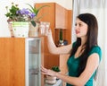 Woman watering flowers in pots Royalty Free Stock Photo