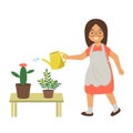 Woman watering flowers with water from a watering can. The girl takes care of home plants, flowers in pots.