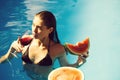 Woman with watermelon and wine in pool Royalty Free Stock Photo