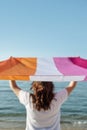 Woman waves a lesbian pride flag