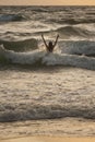 Woman in the waves on sunset Royalty Free Stock Photo