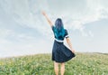 Woman waving her hand outdoor.